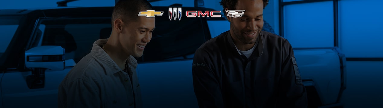 Two Men Looking Down with an Overlay of Chevrolet, Buick, GMC and Cadillac Logos
