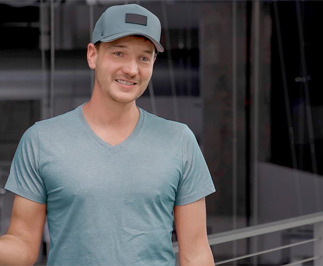 A Smiling Man in a Blue Hat and V-Neck Shirt