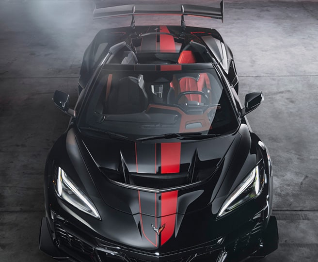A Black Chevrolet Corvette Z06 Sports Car with Red Racing Stripes on the Hood