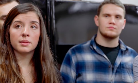 Two Students, a Man and a Woman, in a Classroom