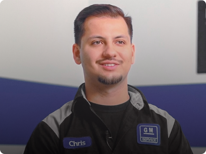 Young Auto Technician Wearing a Black Coveralls Smiling
