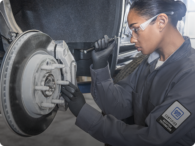 Young Automotive Technician Inspecting Newly Installed Break Pads