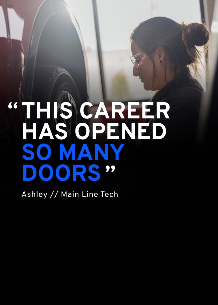 A Technician Named Ashley in a General Motors Certified Service Uniform and Safety Glasses Looking Down