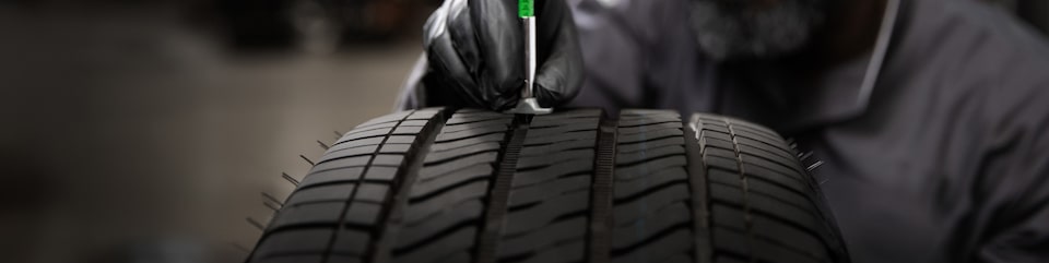 A Mechanic Is Polishing a Tire