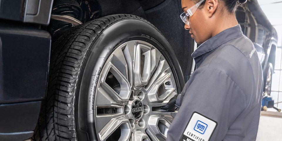 GMC Certified Service Technician Installing a Wheel on a Vehicle