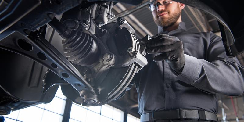 GM Technician with Break Pad and Brake Rotor