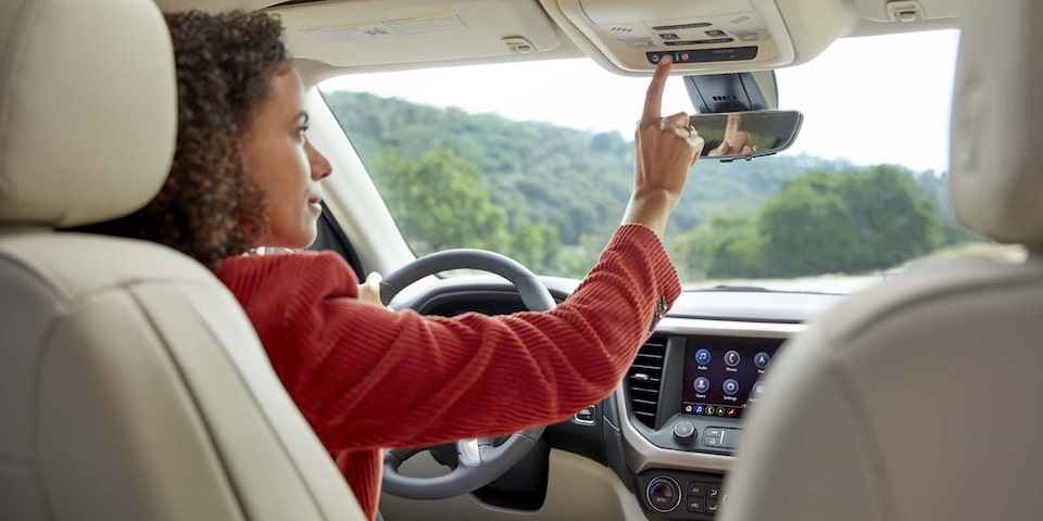 Women In Car Using OnStar Button