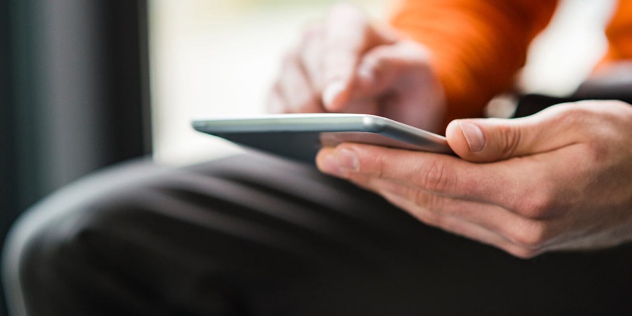 Zoomed In On Man Using Touch Screen On Cell Phone