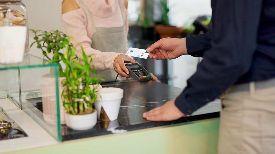 Man Using His My GM Rewards Card at Coffee Shop to Earn Points