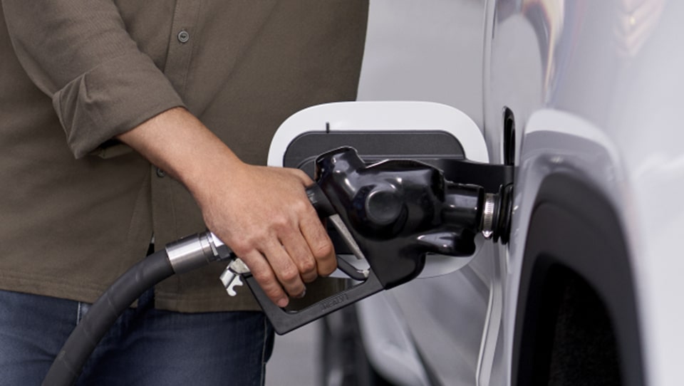 Woman Fueling Her GM Vehicle Using Her GM Business Card