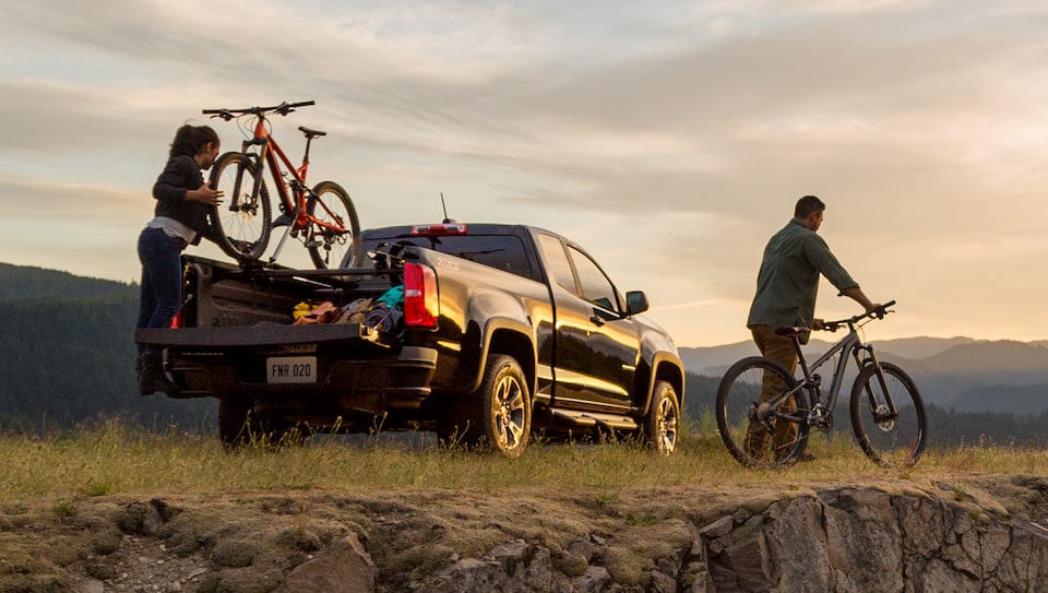 Couple Biking in Nature with their Chevrolet Silverado Truck