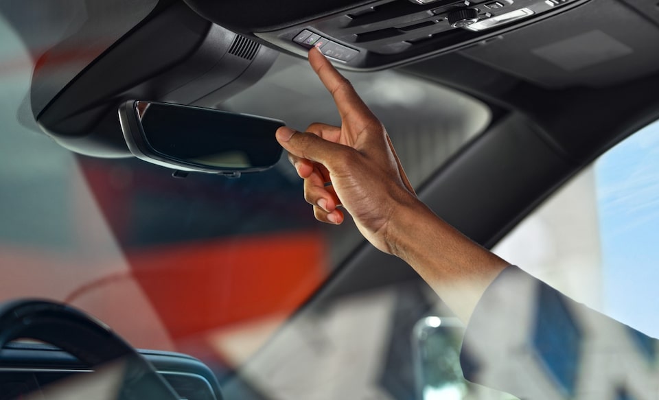 My GM Rewards member pressing OnStar services button
