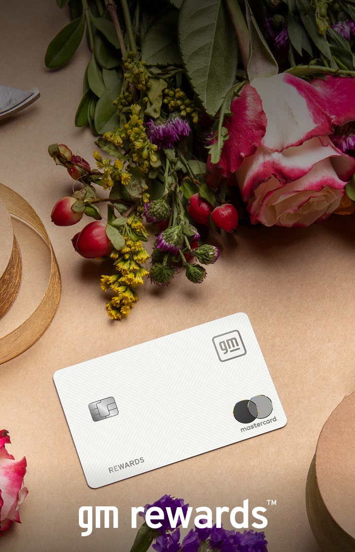 GM Rewards Mastercard on table surrounded by ribbon and flowers
