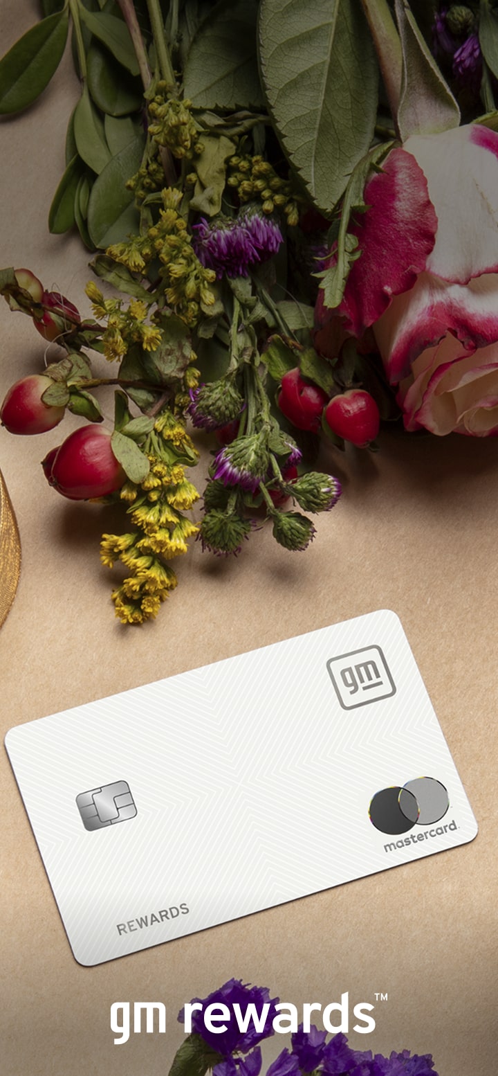 GM Rewards Mastercard on table surrounded by ribbon and flowers