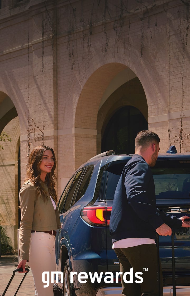 couple with luggage and car