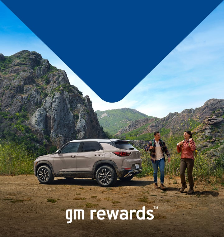 two people in the mountains next to a car