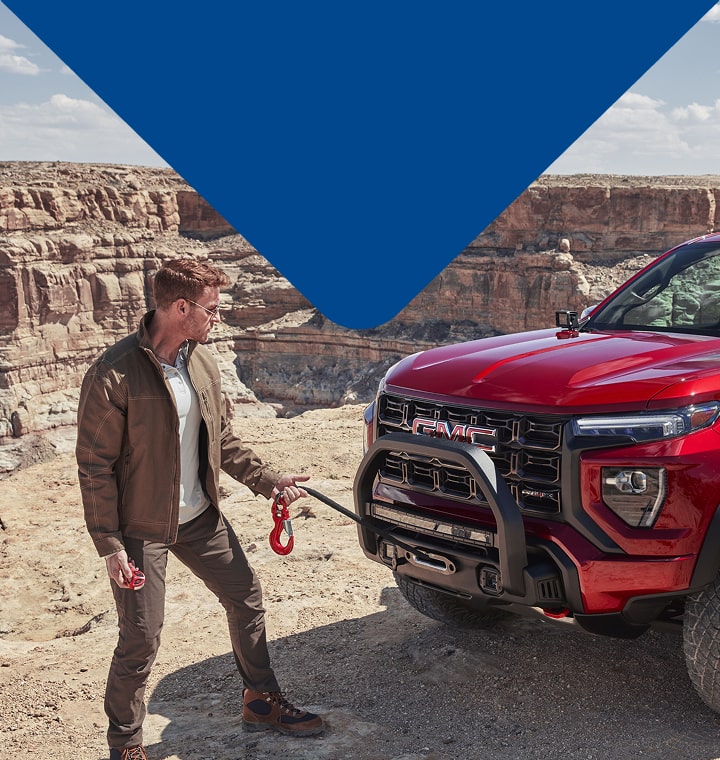 man in front of red truck