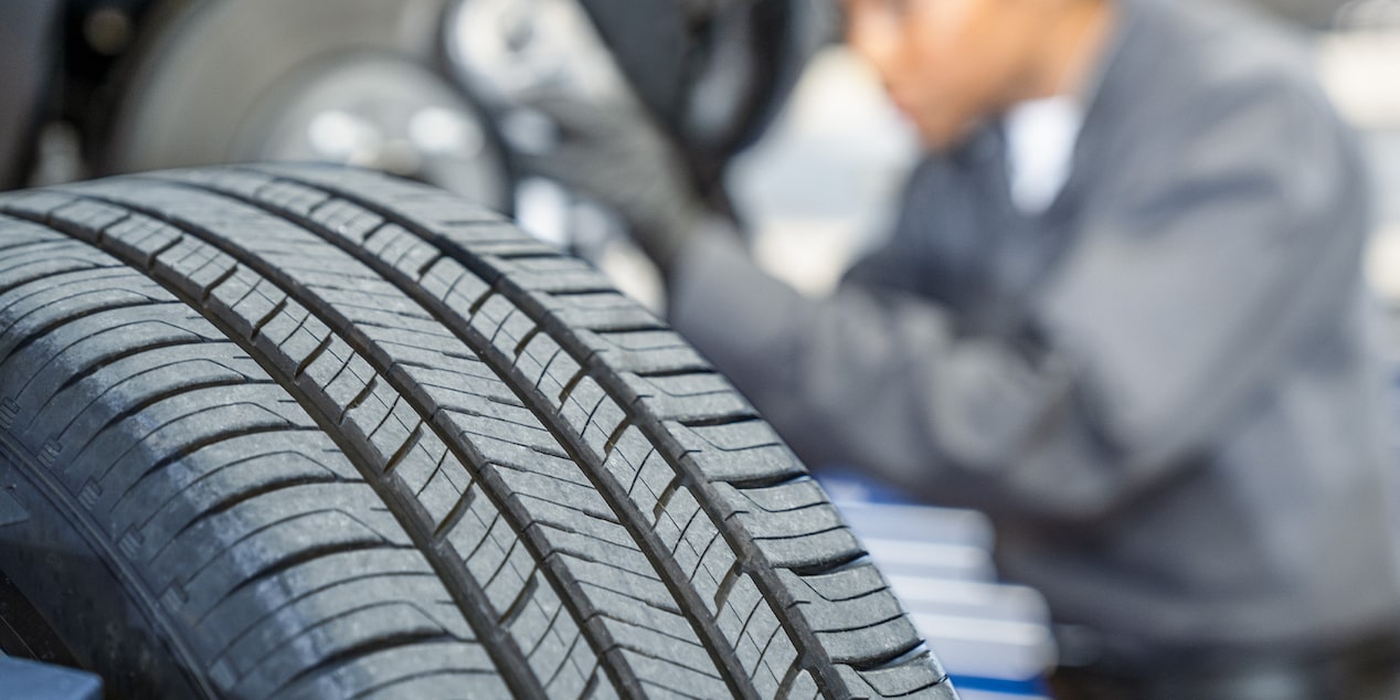 A Buick Certified Service Technician Working on a Buick Vehicle's Tires