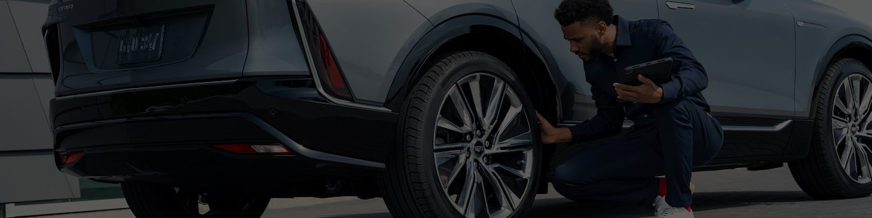 Cadillac Certified Service Technician Inspecting the Wheel on a Cadillac LYRIQ Electric Vehicle