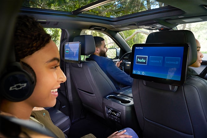 A young girl watching Hulu on the rear seat entertainment system