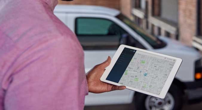 Close-up of a Person Holding a Tablet with a Map Application In Use