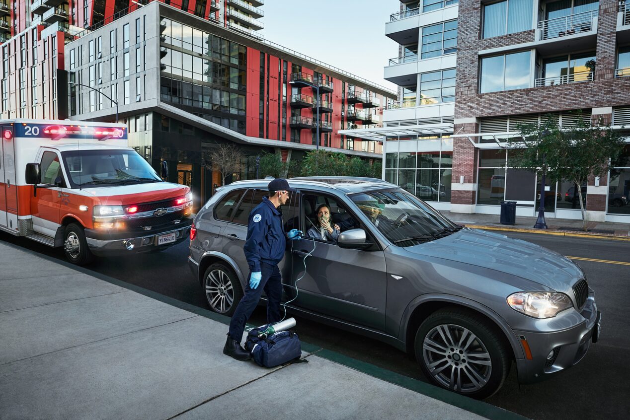 EMT Helping a Vehicle Passenger Through the Window