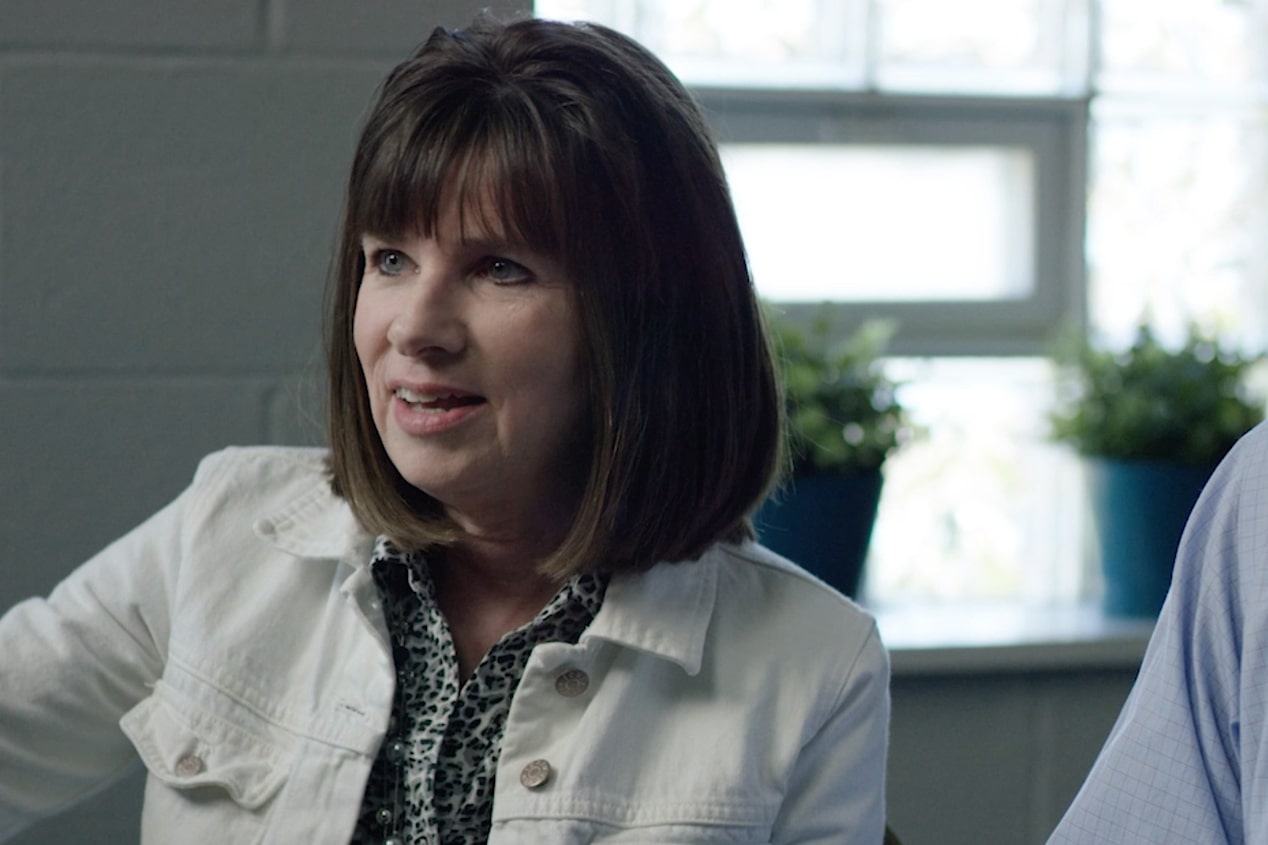 Woman Wearing a White Jacket Speaking in an Interview