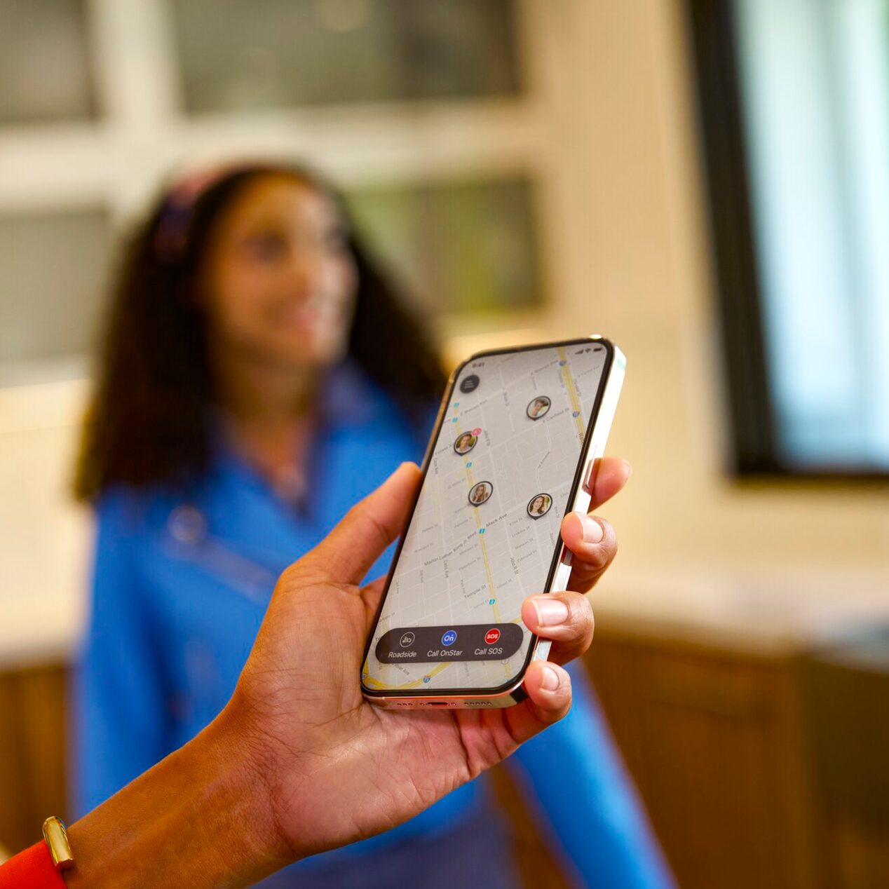 Close up of a person holding phone while guardian app is open