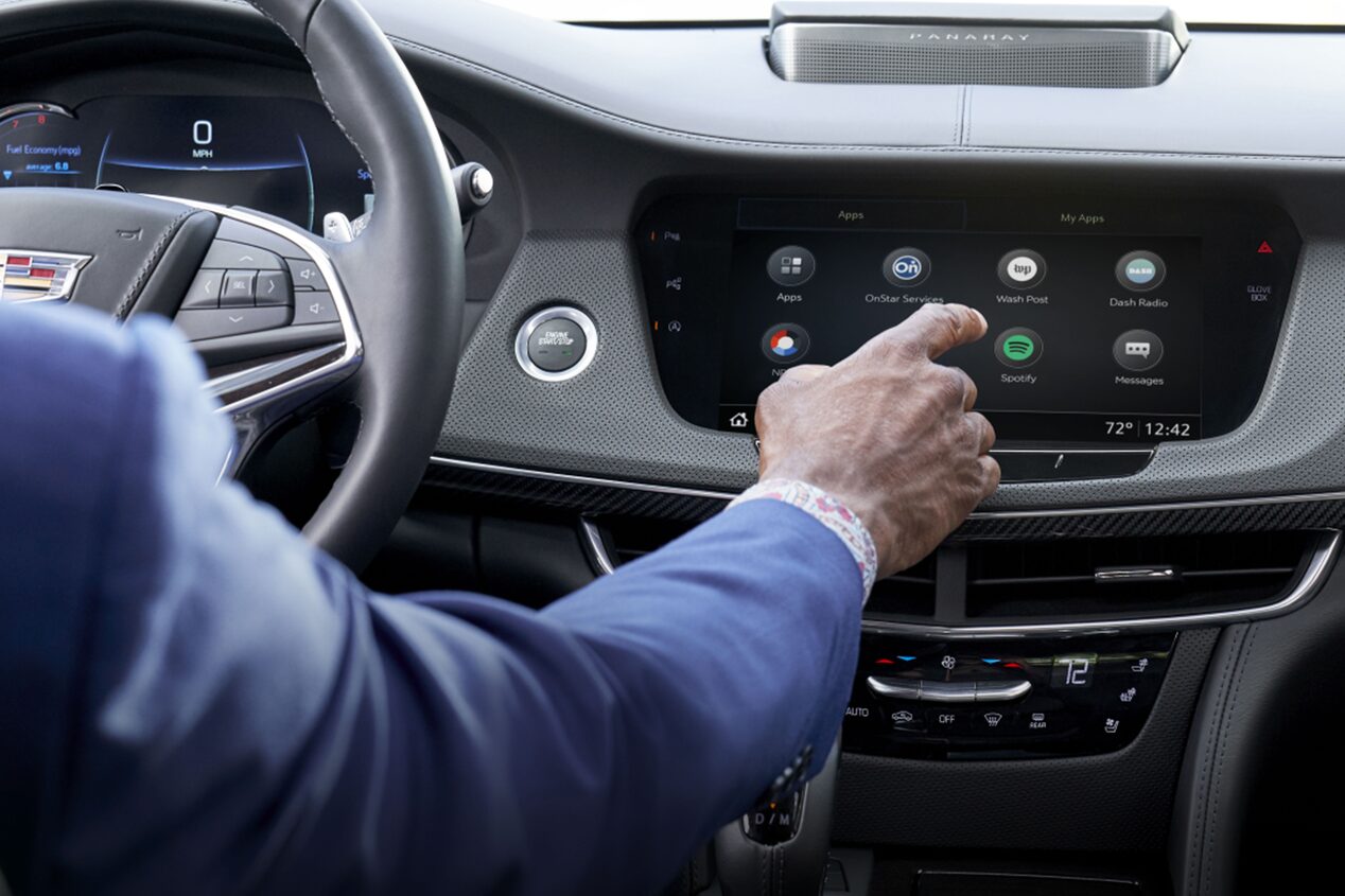 Man Sitting in Drivers Seat Using Infotainment System