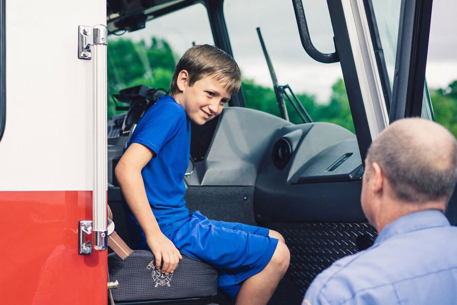 Young Boy Sitting in Passenger Seat of Ambulance