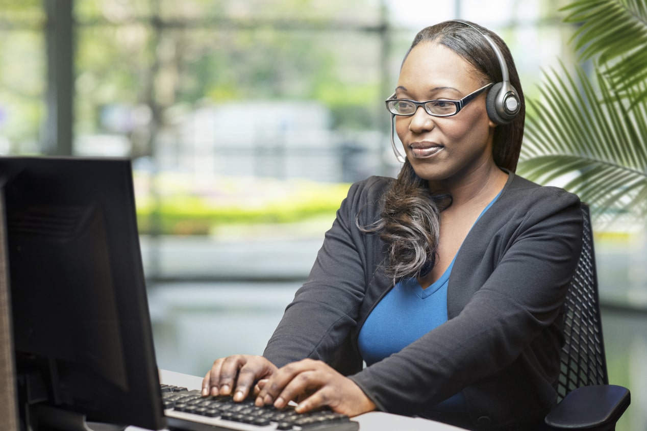 OnStar Advisor On Her Computer Ready to Assist Customers