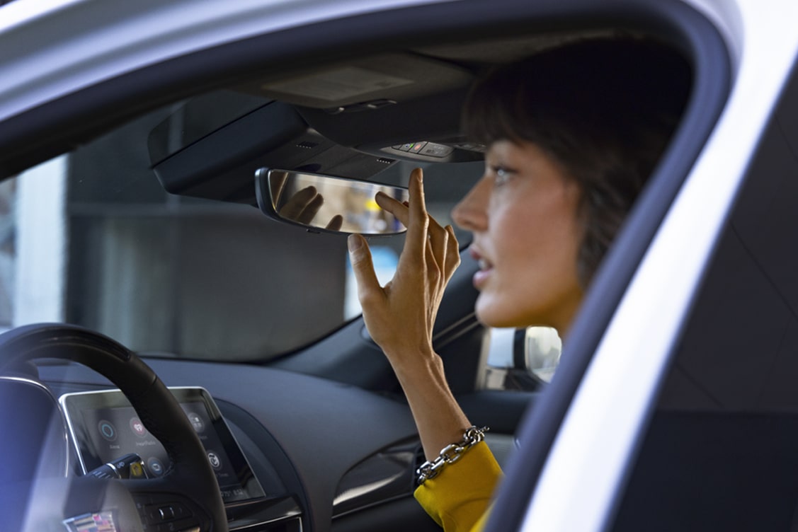 Women Pressing OnStar Button in her Vehicle