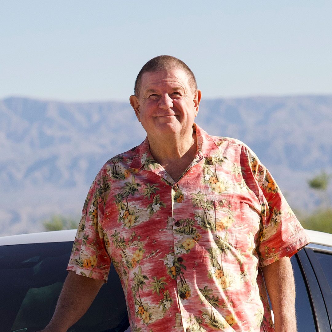 Rusty Austin standing next to his white 2021 Cadillac CT4