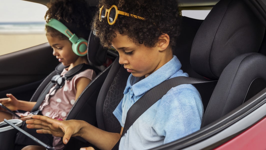 Kids in Their Car Seats Using Their iPads