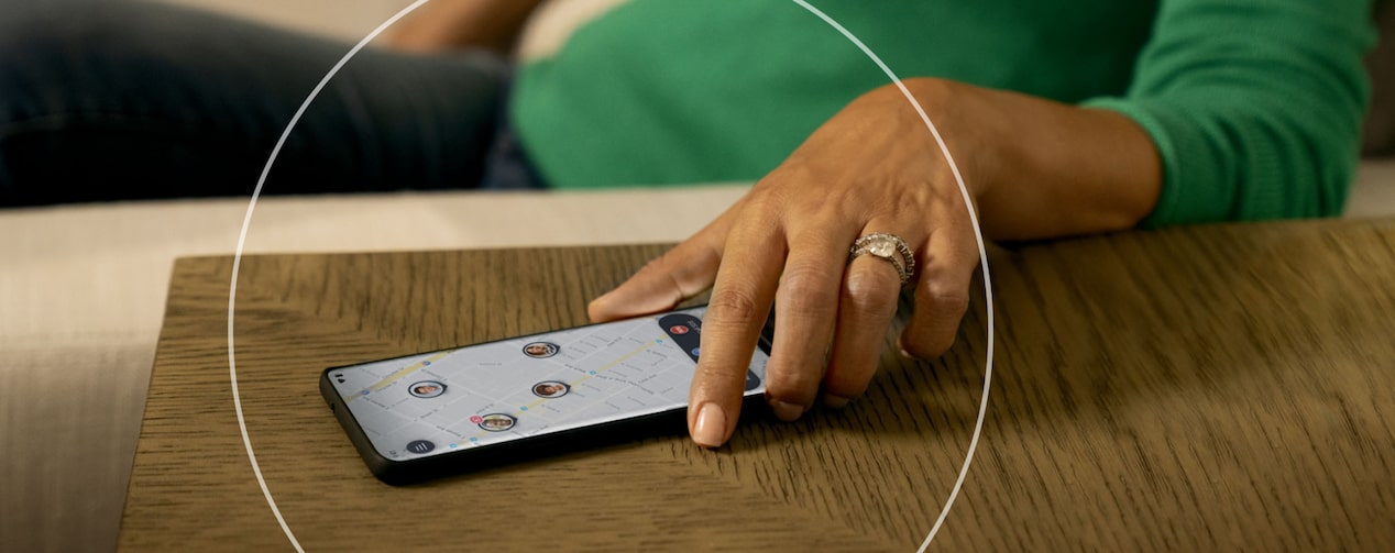 Women Picking her Smartphone up off of a Table