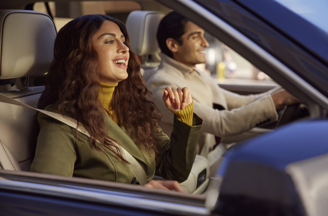 Smiling Man Driving & Smiling Woman in Passenger Seat