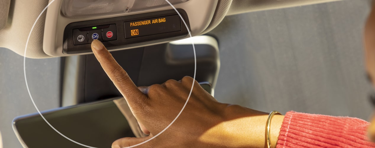 Close up of a Woman Pressing the OnStar Button