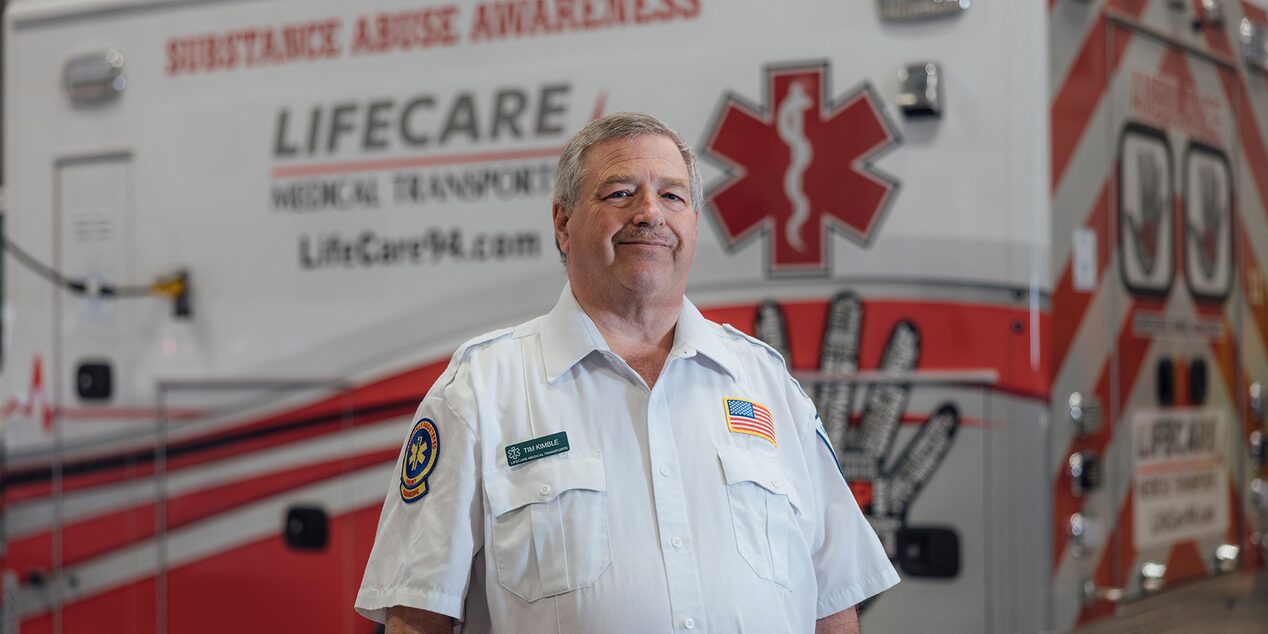 Timothy Kimble First Responder Standing Next to Ambulance