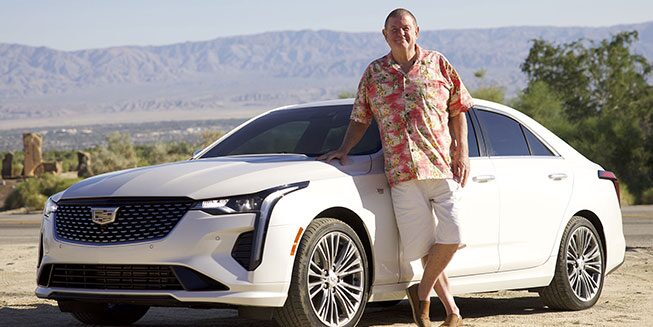 Rusty Austin standing next to his white 2021 Cadillac CT4 