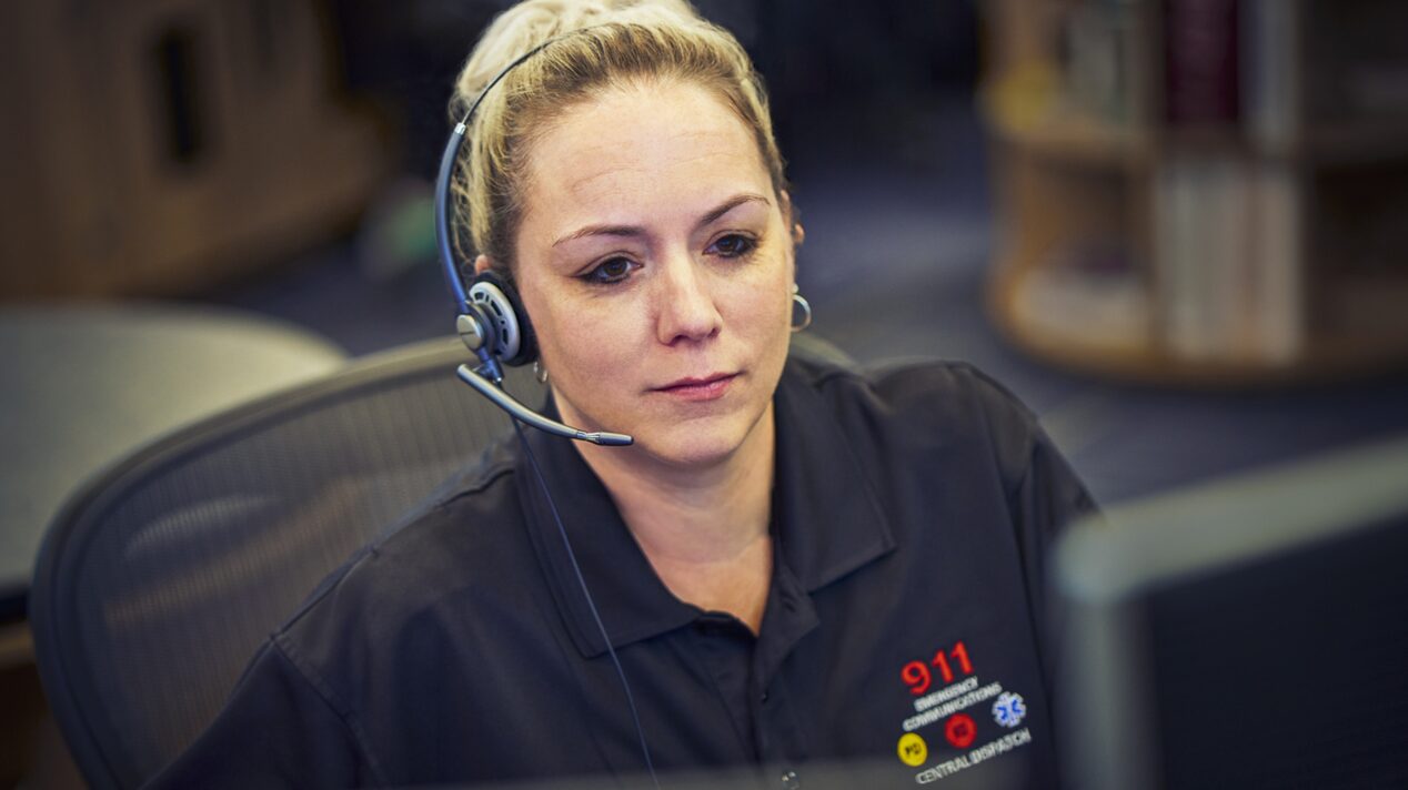 Emergency Dispatcher Glancing Calmly at Computer