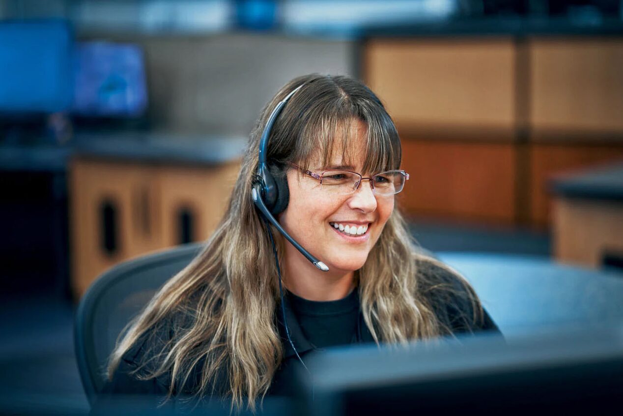Female OnStar Advisor Smiling with Headset on 