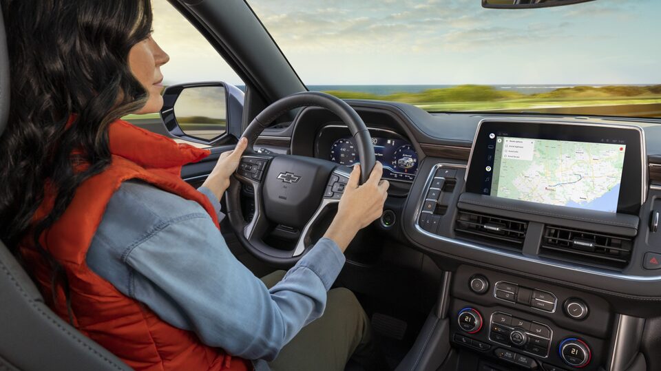 Backseat POV of Woman Driving Wearing Red Vest