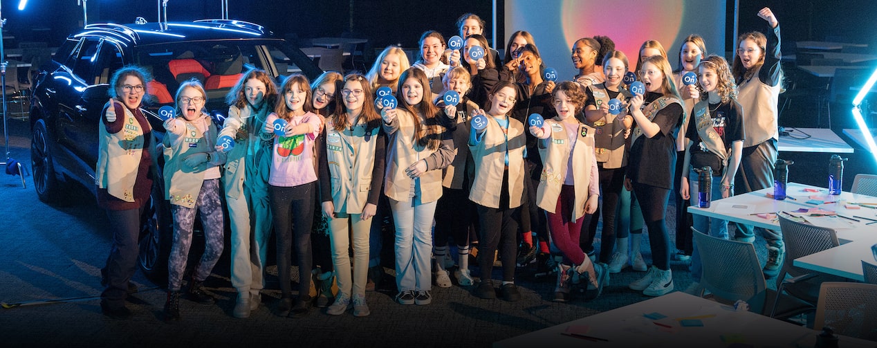 The Girl Scouts standing together for a group picture in the Next Gen Tech Lab room