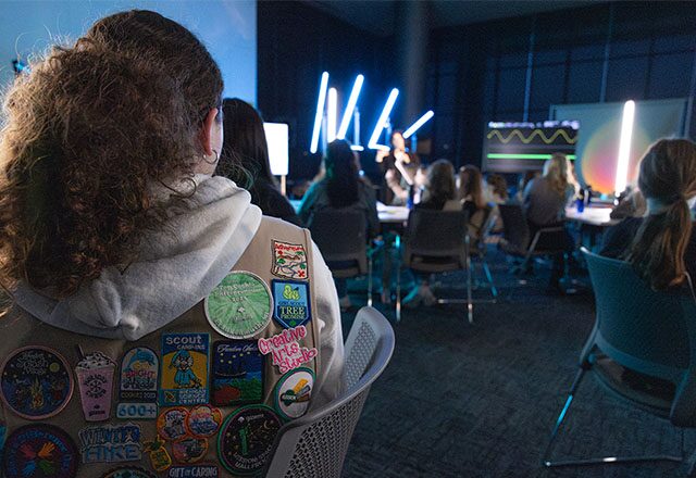 Close up of the back of a Girl Scout vest with all her collected badges