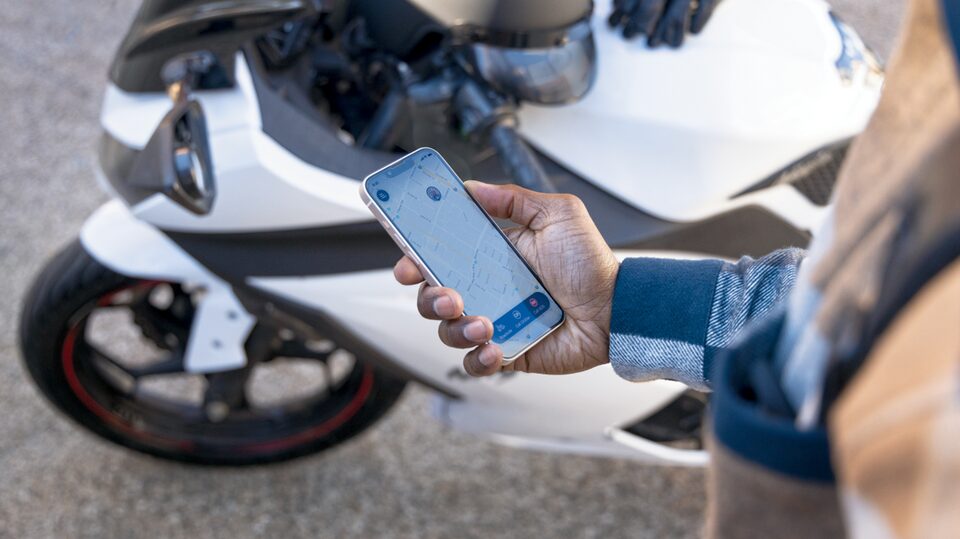 A Woman Using the OnStar Guardian App on her Smartphone