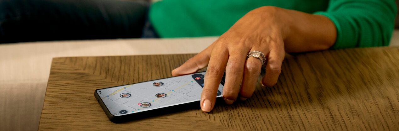 Women Picking her Smartphone up off of a Table