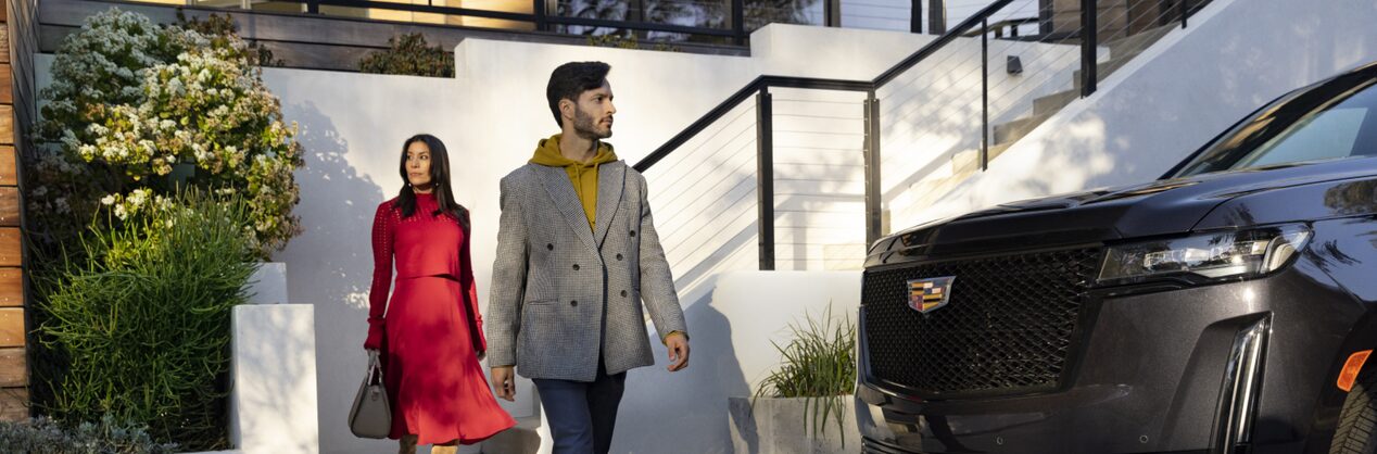 Man and Woman Walking out of their home to their car