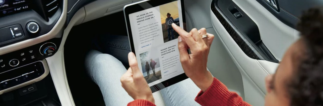 Woman in Passenger Seat Using iPad