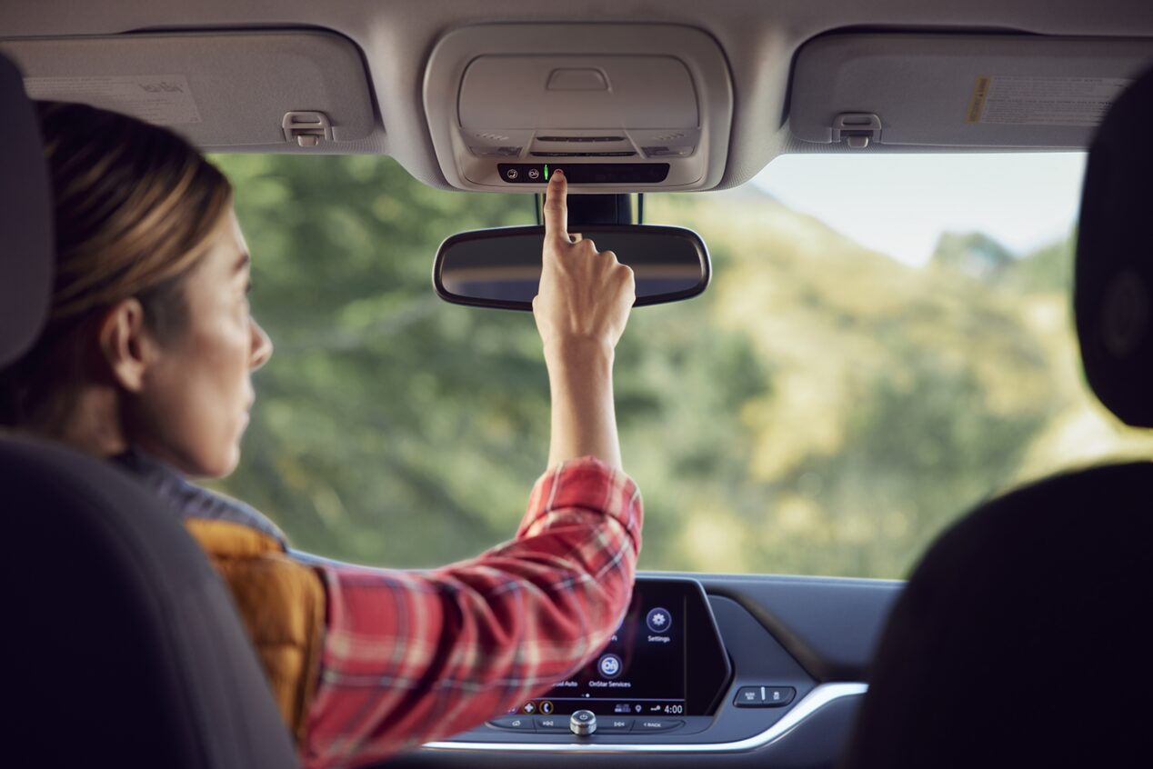 Women Pressing OnStar Button in her Vehicle