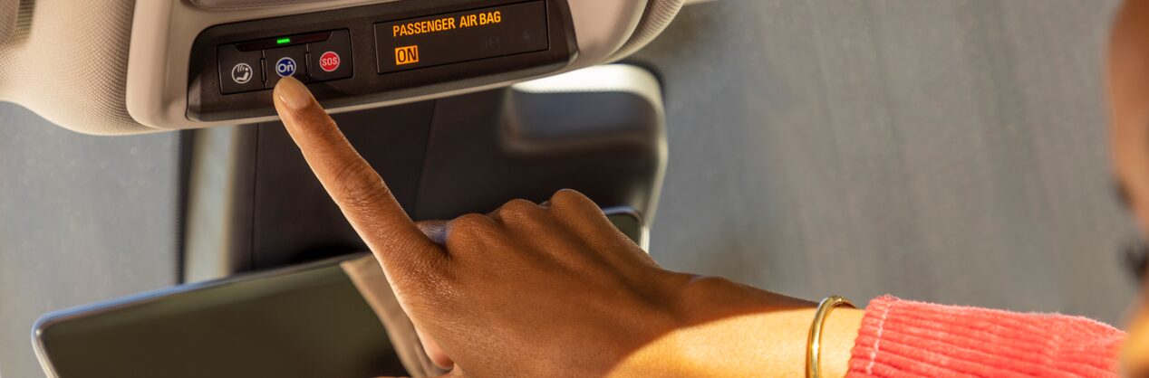 Close up of a Woman Driver Pressing the OnStar Button